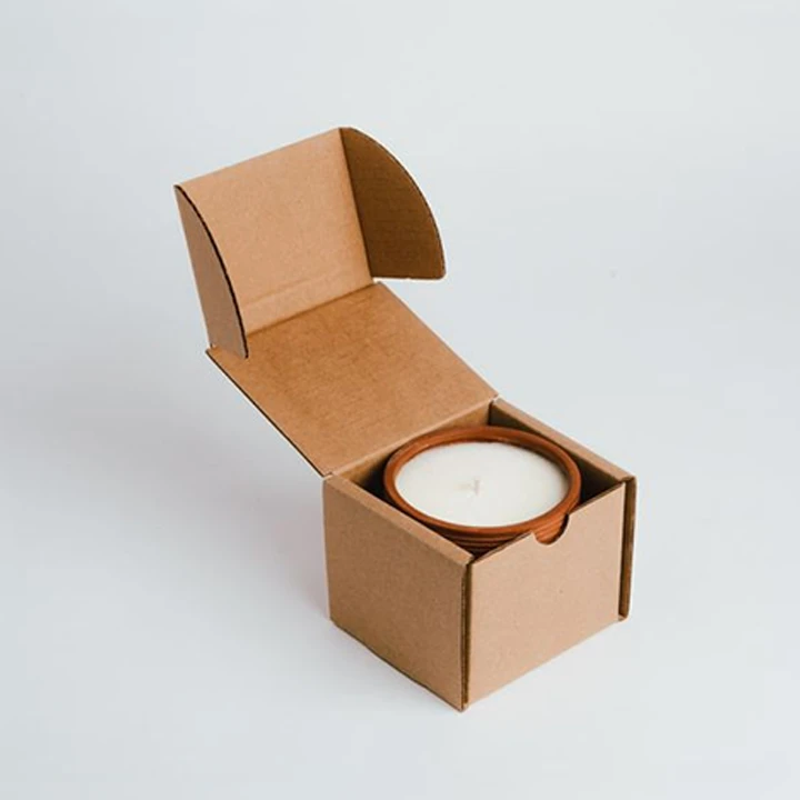 Protective box for candle packaging